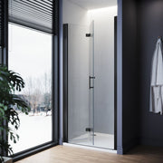 Angled view of black frameless bifold shower door with clear safety glass