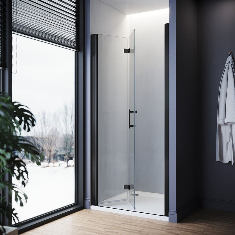 Angled view of black frameless bifold shower door with clear safety glass