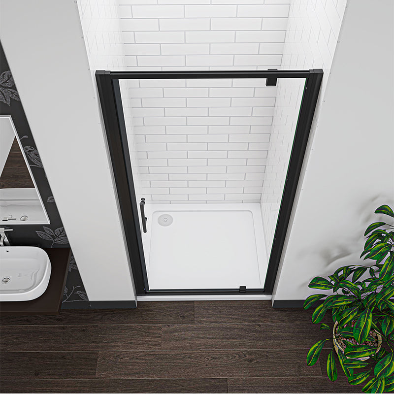 Angled view of matt black framed pivot shower door with tempered safety glass