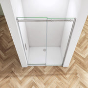 Close-up of chrome frameless sliding shower door showing polished chrome finish, clear safety glass and premium rollers