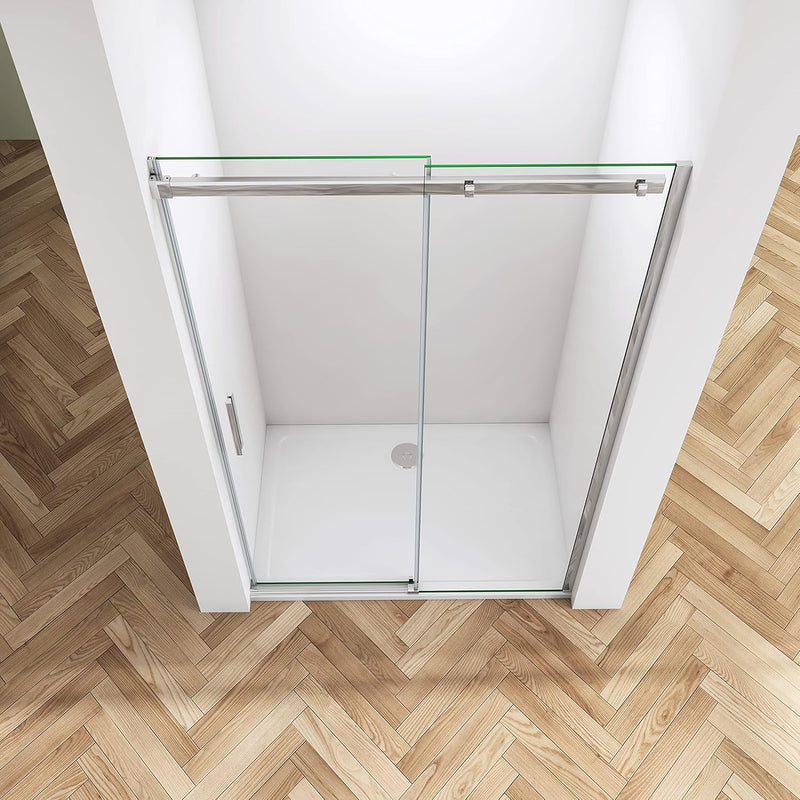 Close-up of chrome frameless sliding shower door showing polished chrome finish, clear safety glass and premium rollers