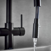 4‑in‑1 kitchen tap matt black – close‑up of control lever and safety button on matt black 4‑in‑1 tap