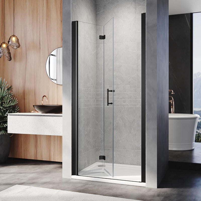 Black frameless bifold shower door installed in a contemporary bathroom