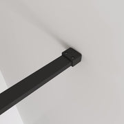 Installed black framed smoked glass walk-in shower screen in a contemporary luxury bathroom